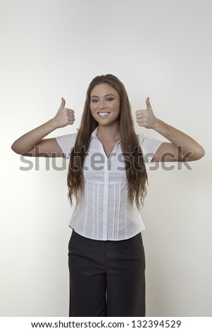 Happy beautiful business woman showing thumb up symbol with both hands