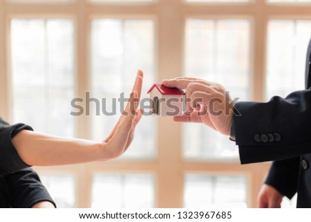 Agents are giving house keys of customer with handshaking after good deal at agency office. Real Estate and (Not Good reject Agreement concept)