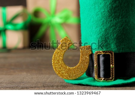 St.Patrick 's Day. celebration. Green hat of a leprechaun and a horseshoe on a brown background. close-up