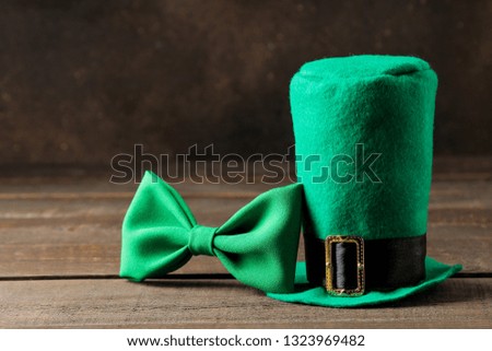 St.Patrick 's Day. celebration. Green leprechaun hat and bow tie on a brown background. space for text