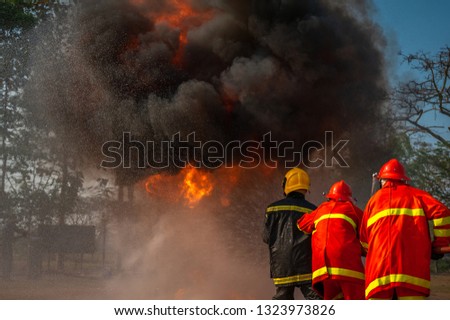 Group of firefighters fighting a fire, Training.