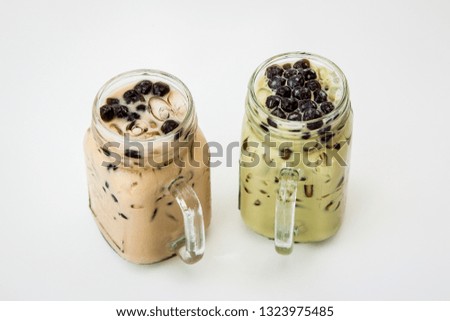 Two glass of drink Taiwan ice milk tea and Taiwan ice milk green tea with bubble boba on white background, Isolate drink in the glass.