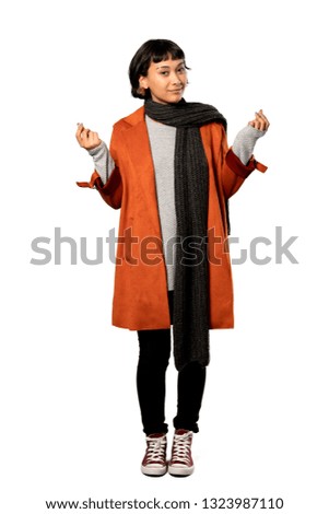 A full-length shot of a Short hair woman with coat making money gesture over isolated white background