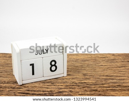 July 18 white cube wooden calendar on vintage wood and white background with summer day, Copyspace for text.