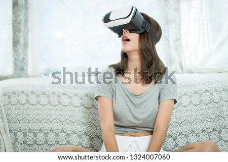 Innovation system visual reality for wath movie or play game hi-tech in new generation. Asian girl are used VR for see the movie and exiting in the experience. 