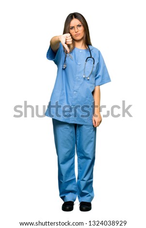 Full body of Young nurse showing thumb down sign with negative expression
