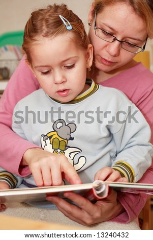 Mother and her daughter reading together