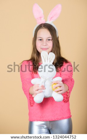 Happy childhood. Easter activities for children. Holiday bunny little girl with long bunny ears. Child cute bunny costume. Kid hold tender soft rabbit toy. Easter day coming. Celebrate easter.