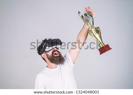 Championship online. Man bearded hipster vr headset holds golden goblet. Feel victory in virtual reality games. Achieve victory. Hipster virtual gamer got achievement. Man winner virtual competition.