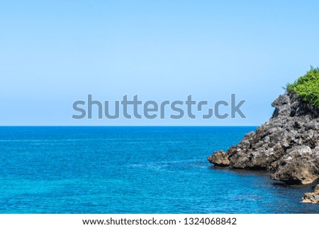 Caribbean island cliff side coastline, epic aqua ocean water. Tropical vacation scenery.