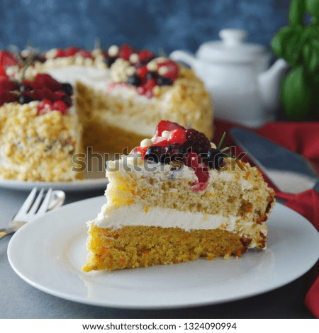 Piece, slice of homemade berry cake. Vegan delicious carrot and orange cake decorated with berries. Healthy dessert. Grey background.