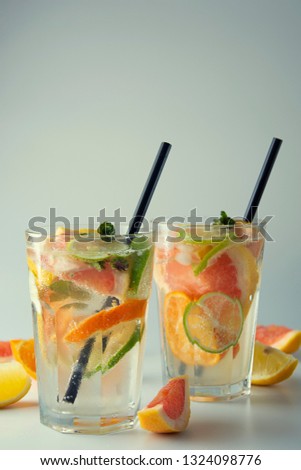 Fresh citrus infused flavored lemonade. Refreshing summer homemade cocktail with lemon, lime, orange and grapefruit