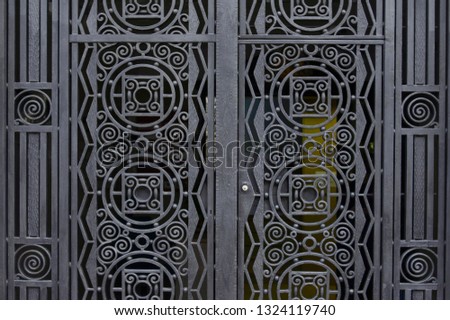Old black metal door background texture close up