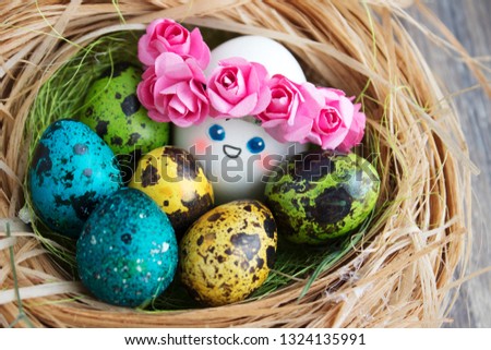 Easter holiday concept with cute handmade eggs, set of kawaii cute eggs with wreaths of pink flowers in the nest.Easter egg