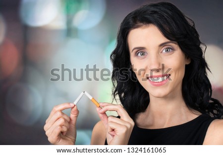 Portrait of the young elegant girl smoking cigarette isolated