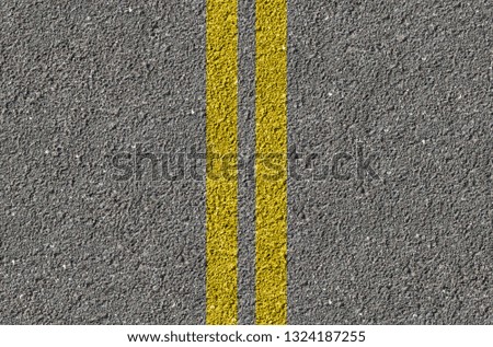 Highway surface with double Yellow Lines. Black asphalt texture. Road marking paint background