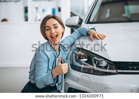 Beautiful woman hugging a car
