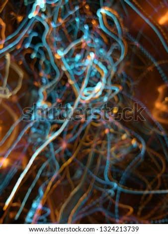 Blurred light effects. Neon glow. Night traffic. Abstract background. Colorful pattern.