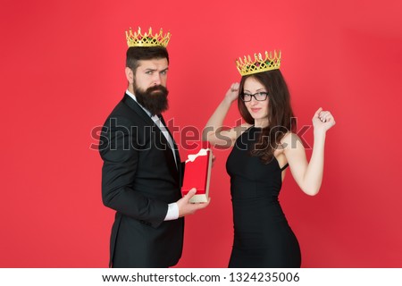 Royal gift. King in tuxedo golden crown giving gift box to queen of his heart. Couple in love royal family. Elite society. King and queen formal event. Royal traditions. Celebrate anniversary.