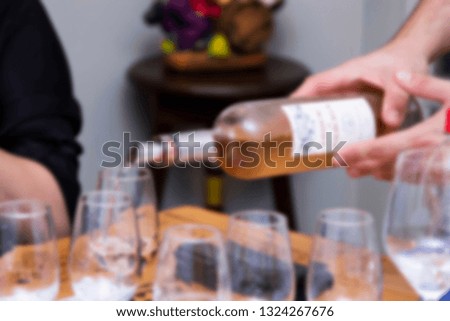 Wine being served in bowls for tasting. Scene with blur