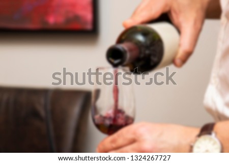 Wine being served in bowls for tasting. Scene with blur