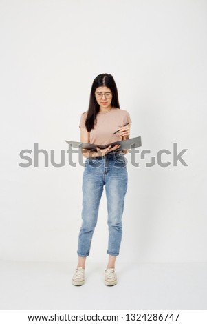 Attractive asian girl in her 35s, Smiling pretty woman face upward thinking or daydreaming while working document paper folder on white background
