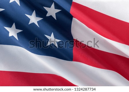 Close-up photo of waving american flag fluttering on the wind
