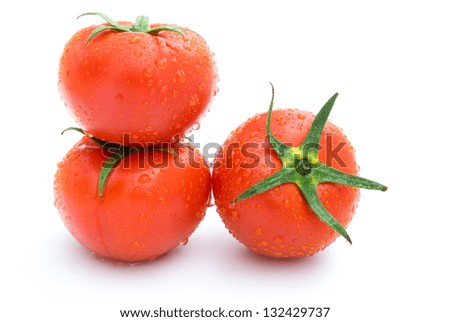 three fresh tomatoes on a white background