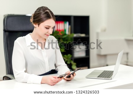 Young businesswoman making online payments using credit card and internet on the laptop in the office