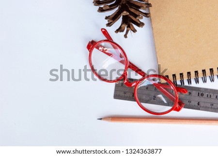 pencils, glasses, Ruler and notebook isolated on white background
