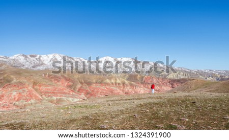 Outdoor photographer traveler in the red mountains