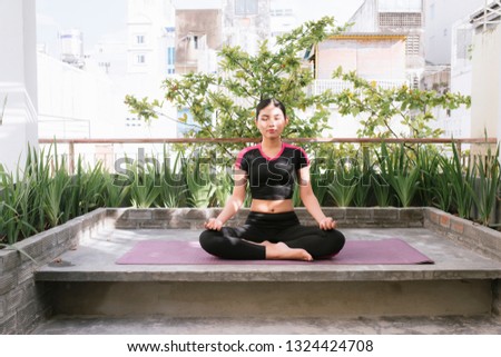 Woman on a yoga mat to relax outdoor.
