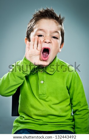 Cute Kid Shouting at Camera Over a Grey Background