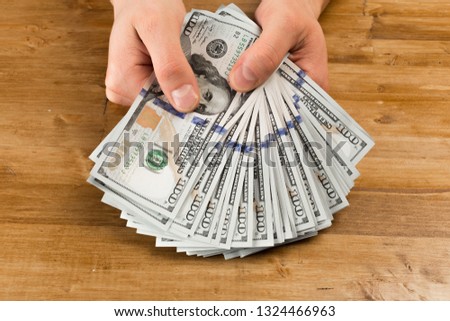 hand, money dollars usa - Image on wooden background