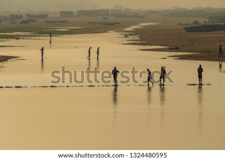 Beautiful Misty Morning People crossing water Somatheeram Beach Kovalam