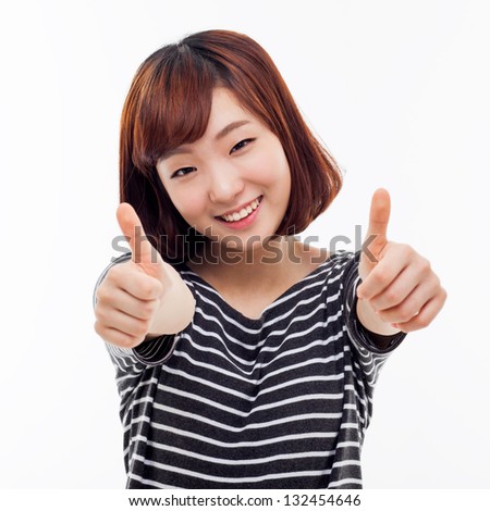 Young Asian woman showing thumb isolated on white background.