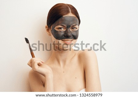 woman in a cosmetic mask made of clay care