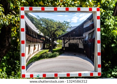 Houses and tree in a transport mirror