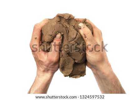 Natural clay piece in hands  isolated on white background.  Wet clay material for sculpting or modeling.
 Royalty-Free Stock Photo #1324597532