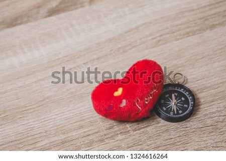 A red heart ball on wooden table with copy space, valentine day 
