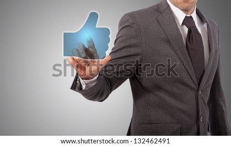 Businessman Presses a Like Button, grey background