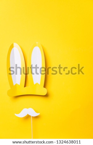 Yellow easter bunny ears with white moustache. Seasonal lay flat backgroud