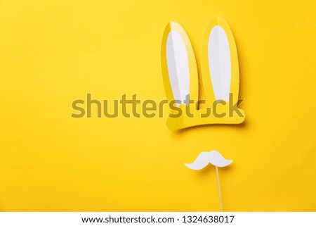 Yellow easter bunny ears with white moustache. Seasonal lay flat backgroud