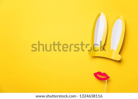 Easter bunny ears and red lips on yellow. Minimal lay flat design