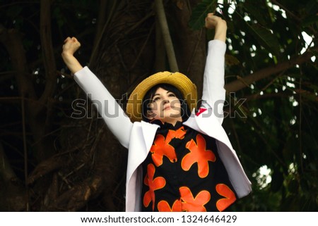 Cosplay of boy girl with straw hat stretches after sleep