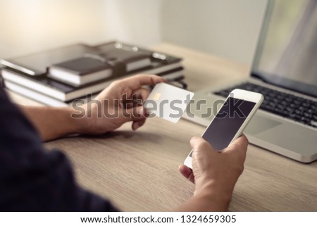 Online payment and lifestyle concept, Male hands using mobile phone for online shopping with credit card.