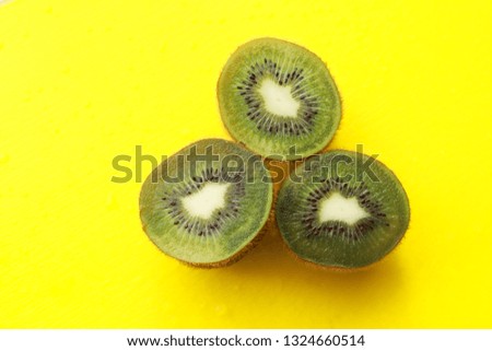Kiwi fruit on yellow background