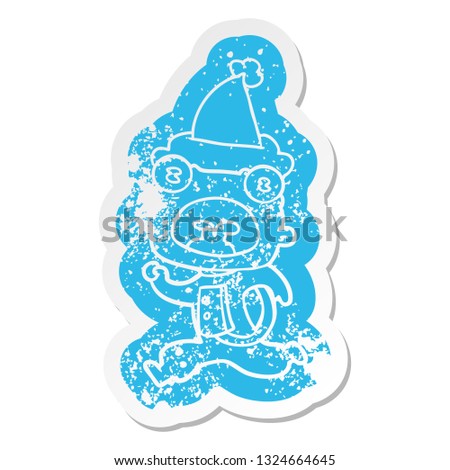 quirky cartoon distressed sticker of a weird alien running away wearing santa hat