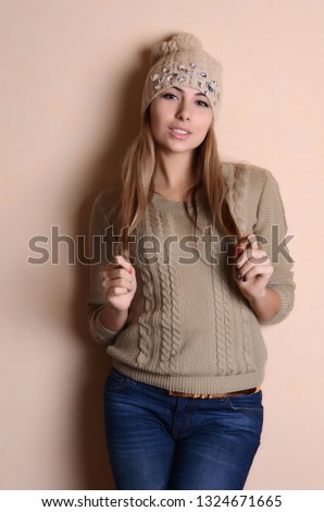 Beautiful girl in winter hat and sweater