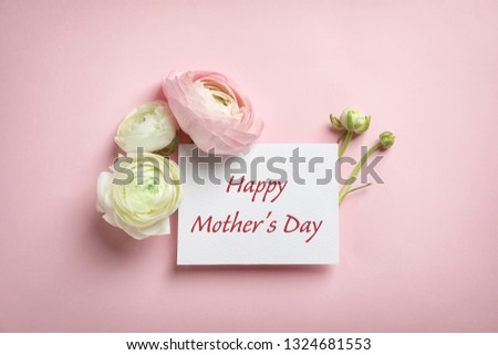 Beautiful ranunculus flowers and card with text Happy Mother's Day on pink background, top view